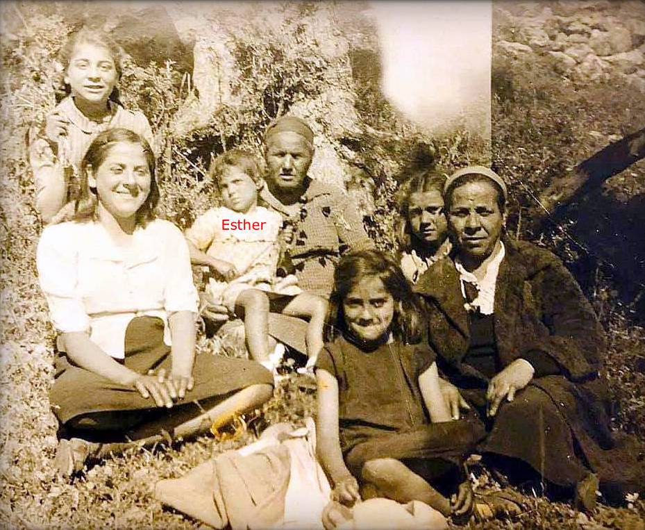 Esther sits on her grandmother's knees, ca. 1945.